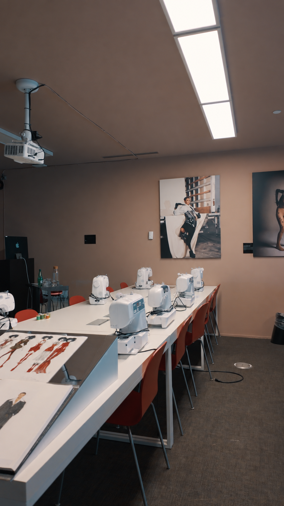 Sewing workspace with samples, worktables and machines